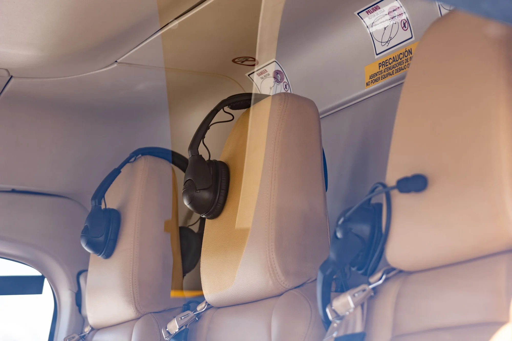 Headsets resting on the seats of a light aircraft