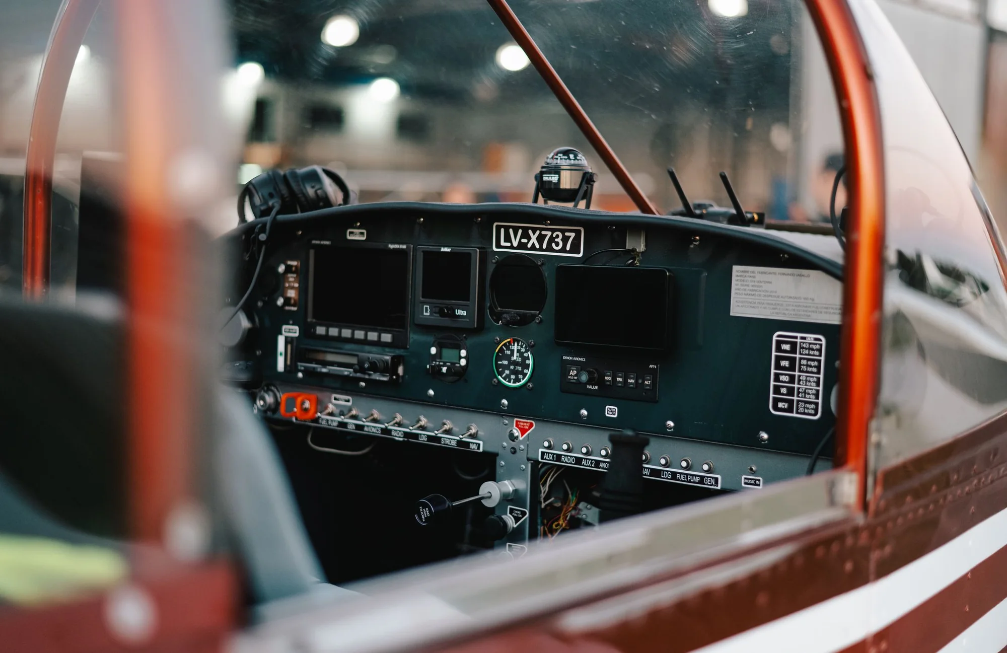 The instrument panel of a light aircraft seen past the canopy frame