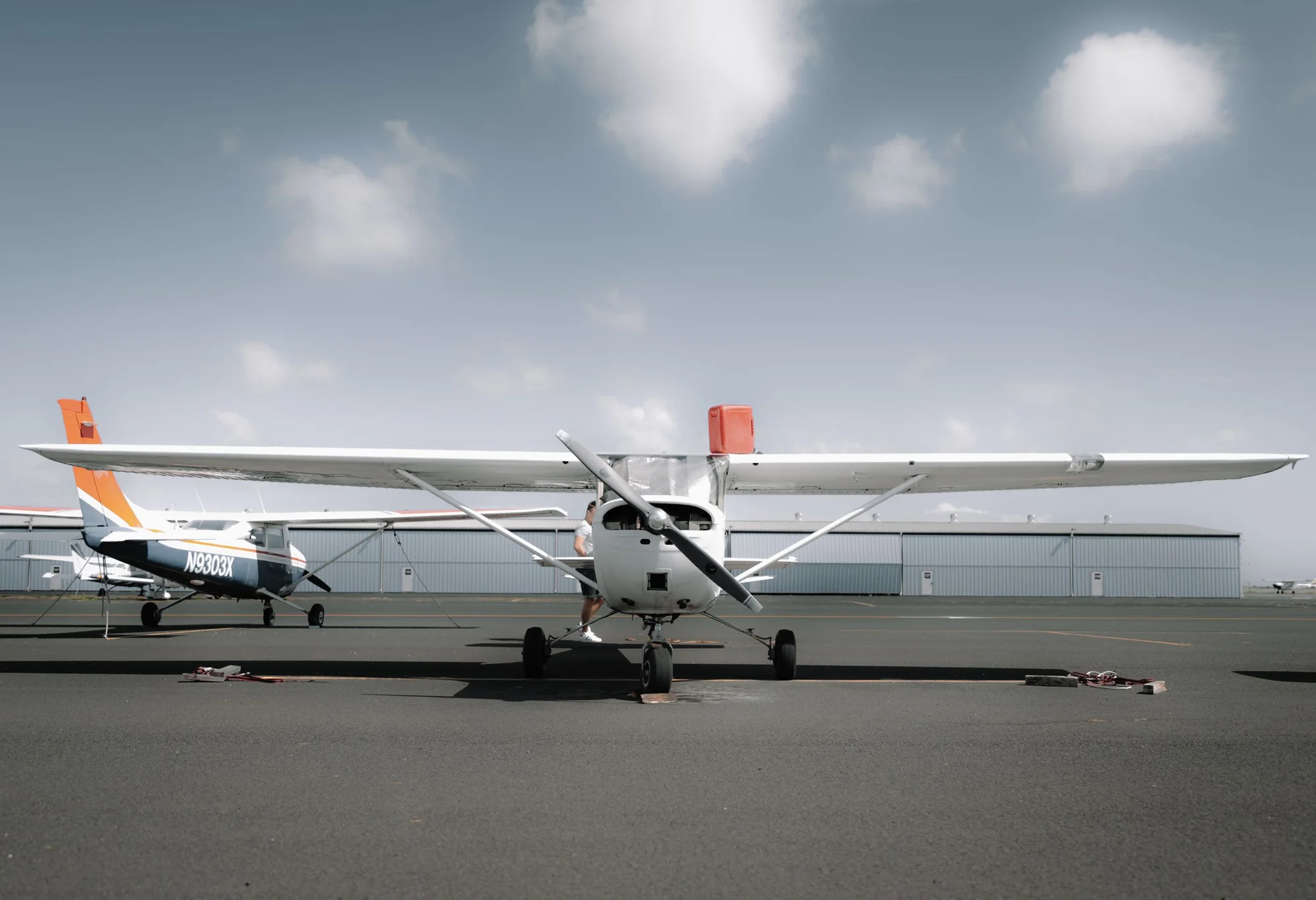 A modern light aircraft parked on an airfield